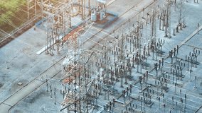 From a bird's-eye perspective, an electrical substation forms a mesmerizing geometric pattern, where wires and transformers create a symphony of electricity.
