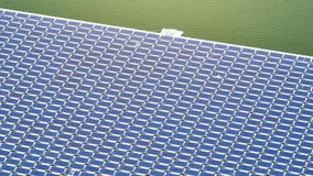 Innovative Floating Solar Panels: Harnessing energy from the sun on water surfaces, floating photovoltaics offer efficient, eco-friendly power generation. Bird's eye view by drone.
 - Powered by Shutterstock - Get 15% off with code: PIKWIZARD15
