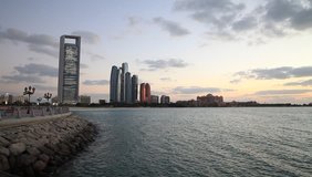 Abu Dhabi skyline with clouds at sunset. Establishing shot. - Powered by Shutterstock - Get 15% off with code: PIKWIZARD15
