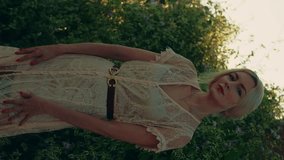 Vertical video of the young beautiful blond woman in summer dress.