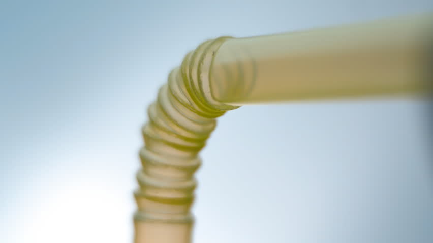 Yellow juice from a glass cup moves up the plastic tube on the light background. Macro. Closeup. Shallow depth of field
 Royalty-Free Stock Footage #33909757