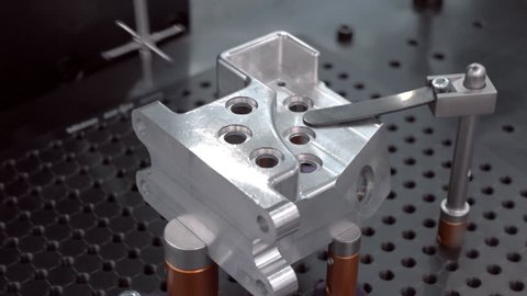 The probe of the coordinate measuring machine (CMM) touch to the detail under researching and introduces data to the computer. Closeup. Shallow depth of field