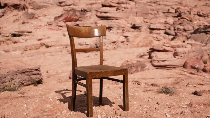 old wooden chair on rocks of Grand Canyon