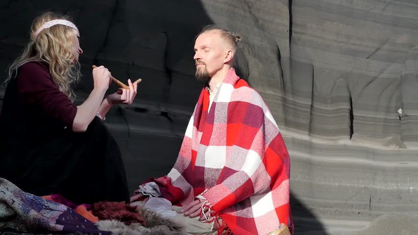 The shaman blew herbal and tobacco powder into the man