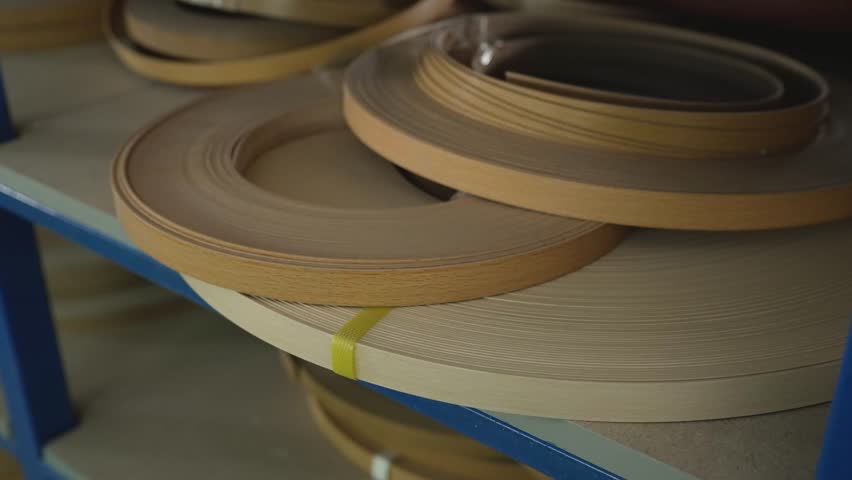 Rolls of veneer edges for the production of furniture parts. Plastic edge banding tape. Tape for gluing furniture fittings. Furniture edge processing.
