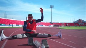 Disabled athletic man stretching and warming up before running on stadium track - Powered by Shutterstock - Get 15% off with code: PIKWIZARD15