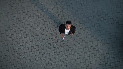 Big City Business Businessman Uses Smartphone and Looks up in Wonder. E-Commerce Visualization Global Business Opportunities Concept. Top-Down Zoom out Aerial Drone Shot Video stock