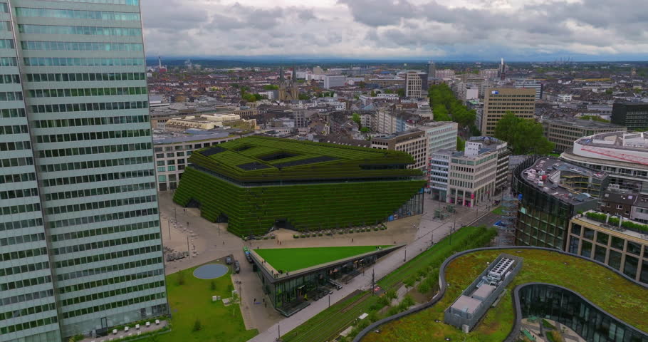 Establishing aerial shot revealing the largest green facade in Europe, a green building envelope to improve the city climate. Business center in Dusseldorf, Germany
