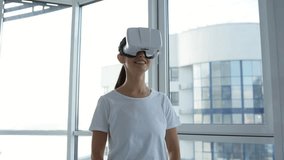 Entertainment. Close up of cheerful woman doing boxing movements while holding light weights and wearing virtual reality glasses