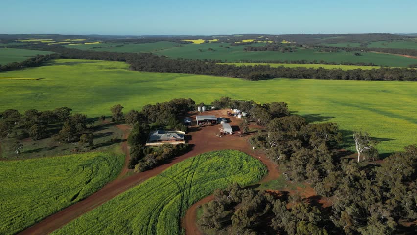 Ranch house surrounded by green Australian countryside, Western Australia. Aerial orbiting