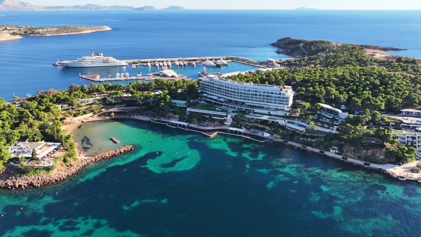 Aerial drone video of recently renovated Marina of Astir beach or Asteras featuring luxury yachts in Vouliagmeni area, Athens riviera, Attica, Greece Royalty-Free Stock Footage #3391303301