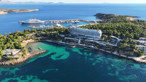 Aerial drone video of recently renovated Marina of Astir beach or Asteras featuring luxury yachts in Vouliagmeni area, Athens riviera, Attica, Greece
