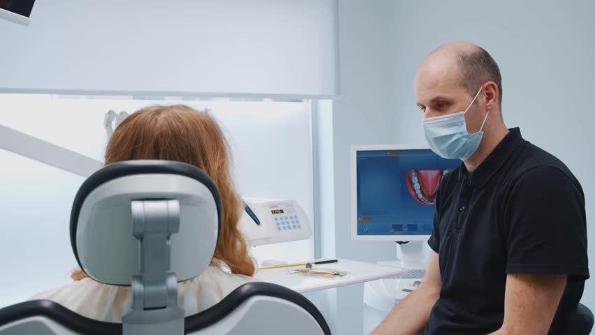 Dentistry. Orthodontic checkup. Professional dentist explains hygiene instructions for young healthy blonde woman in modern clinic office. Healthcare. Treatment. | Shutterstock HD Video #3391305773