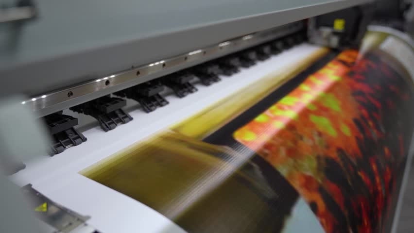 Plotter printing. Printing services and printing. The plotter prints the image.