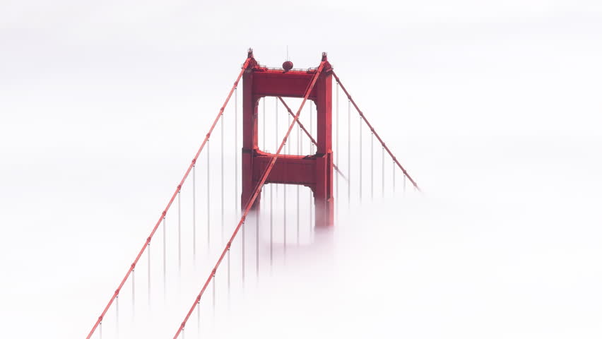 Cinematic bridge covered by dense thick fog with San Francisco downtown on background. Aerial red tall tower of Golden Gate Bridge in scenic white cloud USA.Helicopter overhead red bridge on sunny day Royalty-Free Stock Footage #3391347721