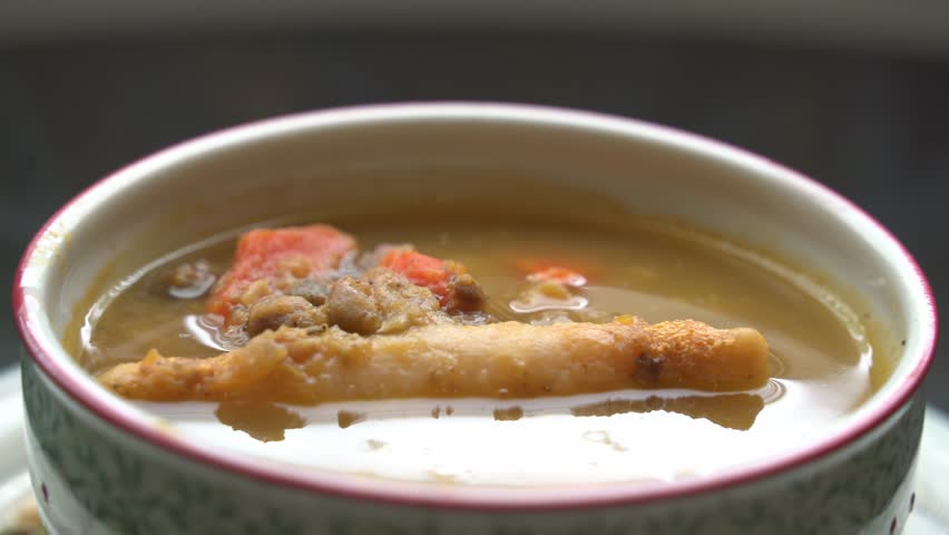 Close up of spoon dipping soup Preparing jamaican gungo pea soup after being picked from tree healthy green fresh protein cultivation harvested
