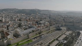 Aerial Footage of the amazing old city in Jerusalem, the walls of the old city, the tower of David and the walls of the old city. The Temple Mount and Al-Aqsa Mosque are visible in the background