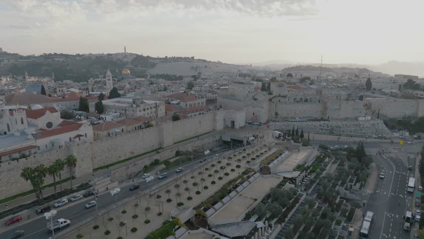 Aerial Footage of the amazing old city in Jerusalem, the walls of the old city, the tower of David and the walls of the old city. The Temple Mount and Al-Aqsa Mosque are visible in the background