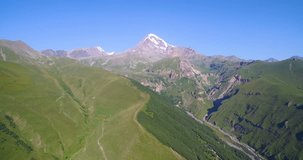 Kazbek with snow top and green foothills drone video