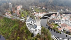 Small historical czech town from above. Aerial Drone View of the red tiled roofs, the castle on the hill and the river. Rozmberk nad Vltavou, South Bohemia, Czech republic