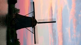 Windmills at famous tourist site Kinderdijk in Holland on sunset with dramatic sky. Kinderdijk , Netherlands