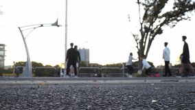 TOKYO, JAPAN : View of unidentified young people playing BASKETBALL in the park. Shot in sunset time. Sports, fitness, exercise and health concept video.