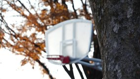 Close up shot of BASKETBALL HOOP in the park. Shot in sunset time. Sports, fitness, exercise and health concept video. Slow motion shot.