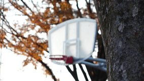 Close up shot of BASKETBALL HOOP in the park. Shot in sunset time. Sports, fitness, exercise and health concept video. Slow motion shot.