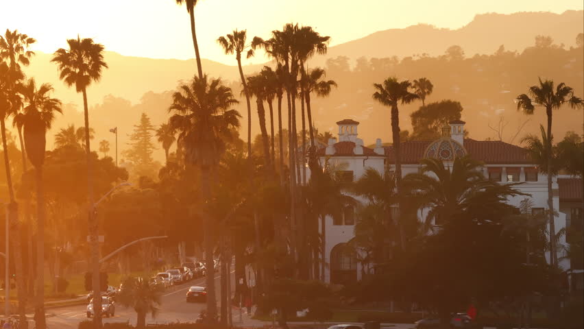 Aerial view of picturesque Santa Barbara skyline at the sunset, California, USA. Palm trees growing on the streets of the resort city. Mountains looking out behind the residential houses, 4k footage  Royalty-Free Stock Footage #3391605877