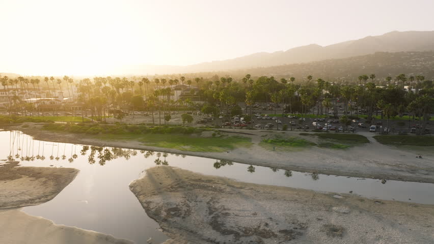 Panoramic view of cityscape of Santa Barbara in sunset light, California, USA. Drone shot of city beach along Pacific Ocean. Picturesque landscape of mountains, ocean and city skyline, 4k footage  Royalty-Free Stock Footage #3391606307