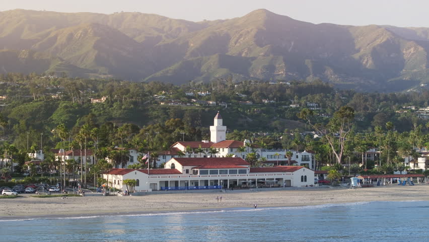 Drone shot of resort hotels located at the Pacific Ocean, Santa Barbara, California, USA. Panoramic view of city landmark with mountains on background. Breathtaking landscape at sunset, 4k footage  Royalty-Free Stock Footage #3391608357