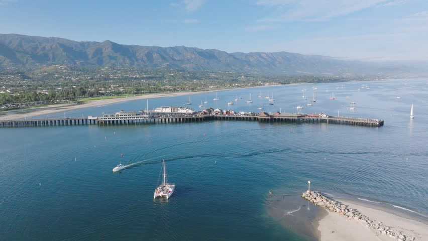 Panoramic view of Santa Barbara coastline and Stearns Wharf, California, USA. Drone shot from Point Castillo on picturesque harbor with yachts. Mountains landscape and Pacific shoreline, 4k footage Royalty-Free Stock Footage #3391612667