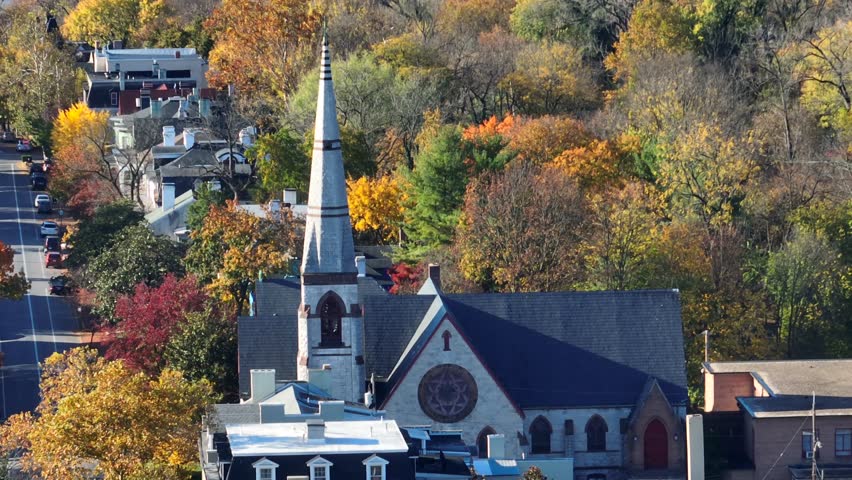 Church steeple in American town during autumn. Aerial view.