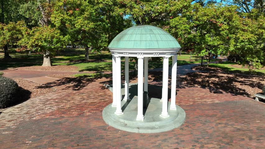 Famous Old Well, a historical landmark inside University of North Carolina Chapel Hill campus. Aerial rising shot.
