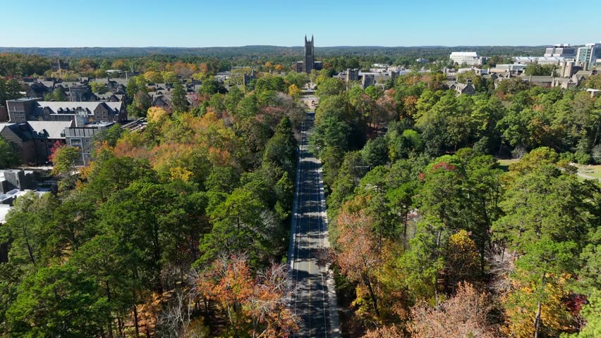 Duke University in autumn. Aerial flight above Chapel Dr towards stone Cathedral.