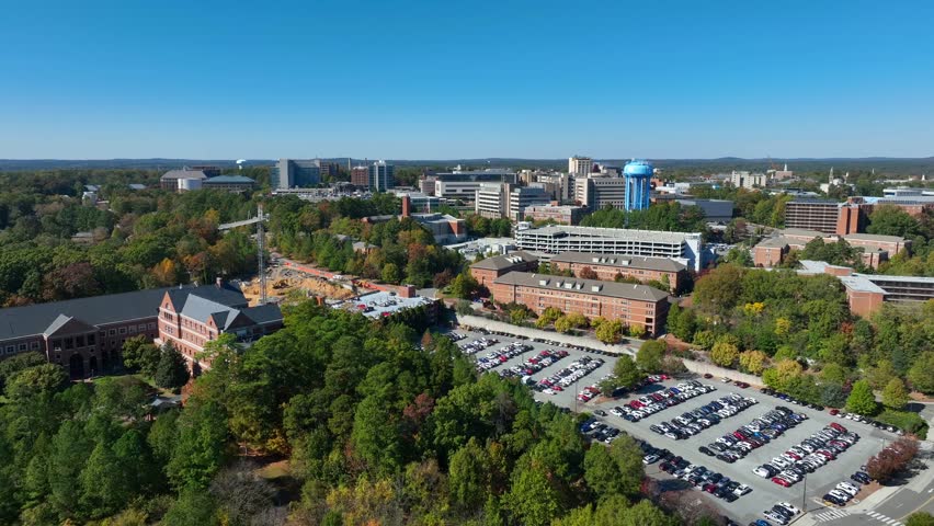 UNC Chapel Hill campus revealing Dean E. Smith Center for basketball on University of North Carolina. Aerial reverse shot.