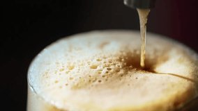 Beer pouring into the glass, close-up of dark beer foam. - Powered by Shutterstock - Get 15% off with code: PIKWIZARD15