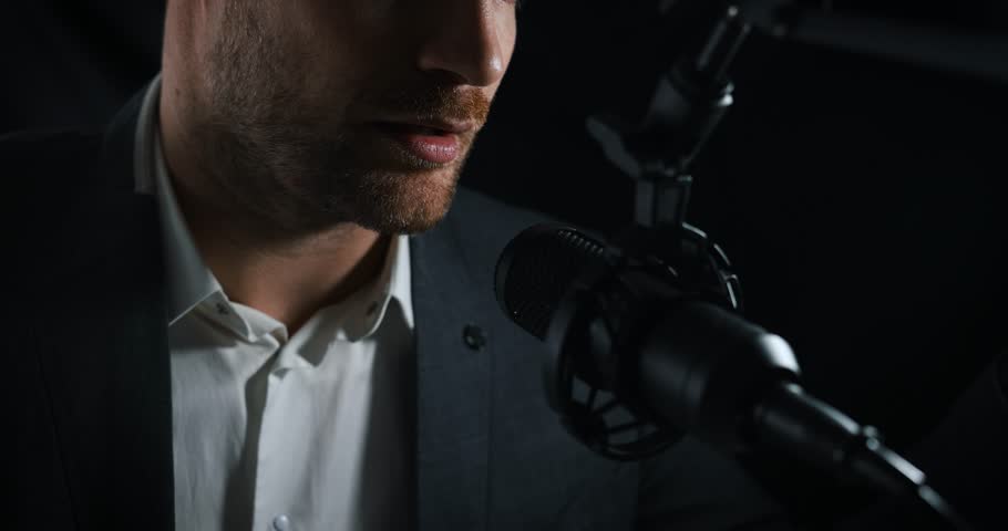 business podcast or radio interview recording. closeup of businessman talking in microphone in broadcasting studio Royalty-Free Stock Footage #3391838053