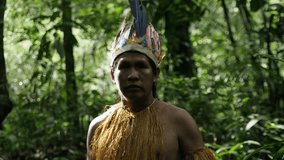 Portrait shot of an indigenous man in the dense jungle in Leticia, Amazon area, Colombia