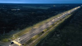 The freeway at night is illuminated by streetlights. Sprawling Six-Lane Freeway Stretching Through Lush Countryside - Powered by Shutterstock - Get 15% off with code: PIKWIZARD15