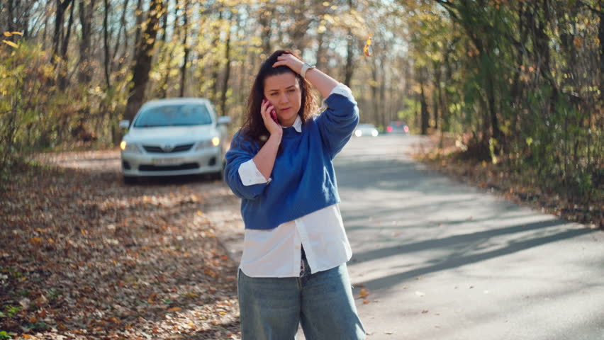 Emergency Call: Upset Woman Dealing with Car Breakdown Talks on the Road. High quality 4k footage | Shutterstock HD Video #3391903223