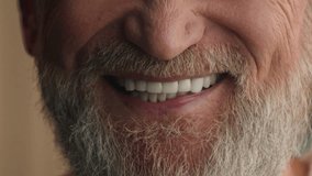 Close up male white healthy teeth smiling cropped view happy satisfied smile cheerful positive unrecognizable old senior mature man with gray hair beard bearded grandfather dental prostheses medicine - Powered by Shutterstock - Get 15% off with code: PIKWIZARD15