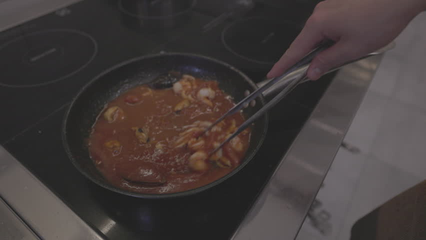 Italian Pasta Cooking Process. Cooked pasta is mixed with sauce and toppings in a hot pan. Italian cuisine, traditional recipe. Slow motion 120 fps, ProRes 422, 10 bit, ungraded C-LOG video | Shutterstock HD Video #3391979601