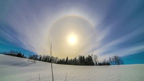 Timelapse shot of beautiful sun halo during afternoon time over white snow covered field. - Powered by Shutterstock - Get 15% off with code: PIKWIZARD15