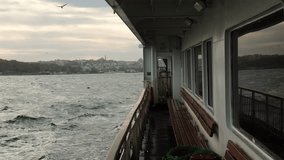 Wavy sea from ferry in Istanbul in slow motion with reflections on windows.