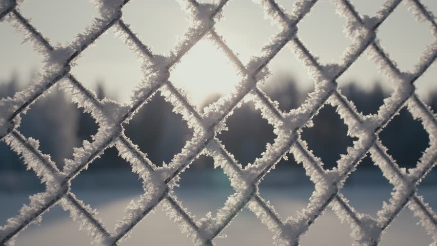 Iron fence covered with frost. Slow motion video. High-quality shooting in 4K format Royalty-Free Stock Footage #3392109157