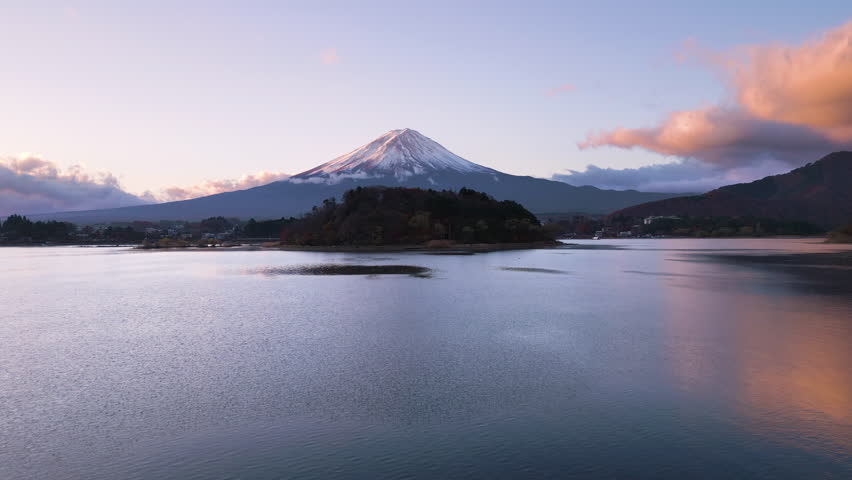 aerial view drone of mount fuji at sunrise,flying low over lake water sunny autumn day