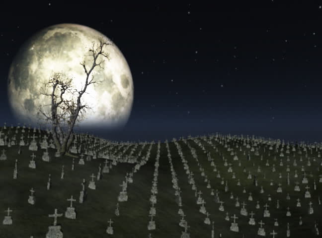 Graveyard with full moon behind,ground fog and tree flowing in the wind