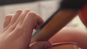 close up musician hands playing cello	
