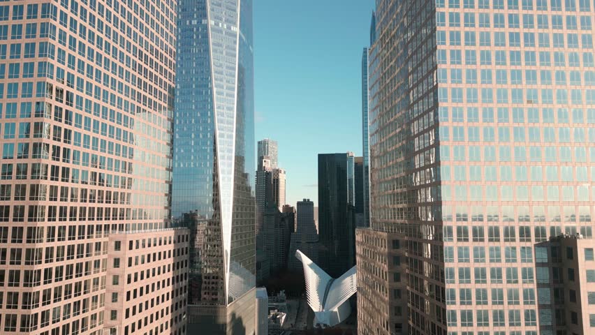 Manhattan view from above. Forwards fly above street between modern buildings. Day in Manhattan, NYC aerial view. New York City, Manhattan view from drone. NYC, Manhattan skyline. City scene NY, USA.